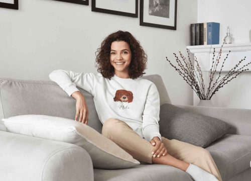 sweatshirt-mockup-featuring-a-woman-sitting-on-a-couch-while-smiling-m9835-r-el2-1